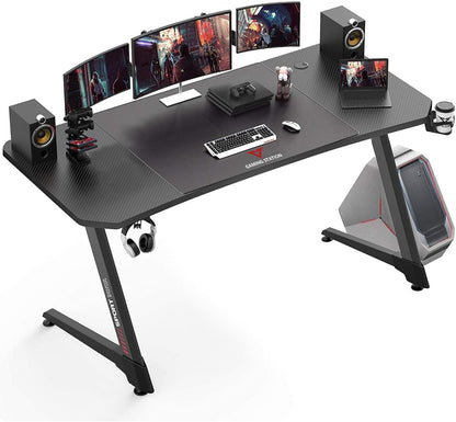 63 Inch Ergonomic Gaming Desk, Z Shaped Office PC Computer Desk with Large Mouse Pad, Gamer Tables Pro with USB Gaming Handle Rack, Stand Cup Holder and Headphone Hook, Black